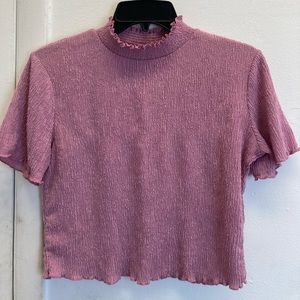 Ribbed pink slightly cropped shirt.
